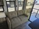 2027 Cherokee Timberwolf 20OG sofa beside rear patio doors