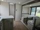 2027 Forest River Acclaim 26RB living area with dinette and sofa