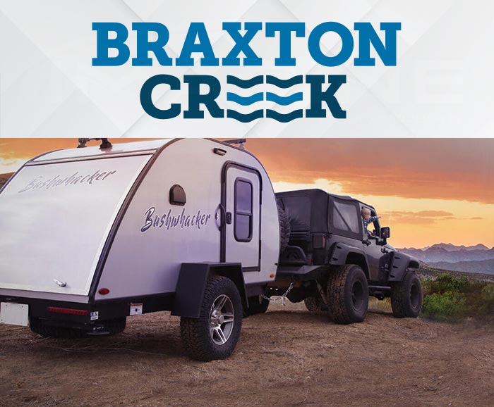 Photo of Braxton Creek Bushwhacker teardrop camper being pulled by a Jeep, with logo above.