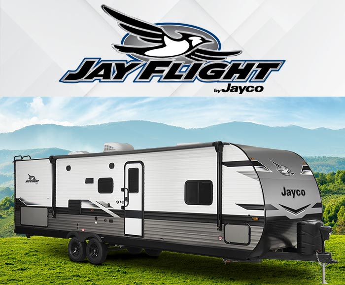 Photo of Jayco Jay Flight travel trailer with mountains in the background and logo above.