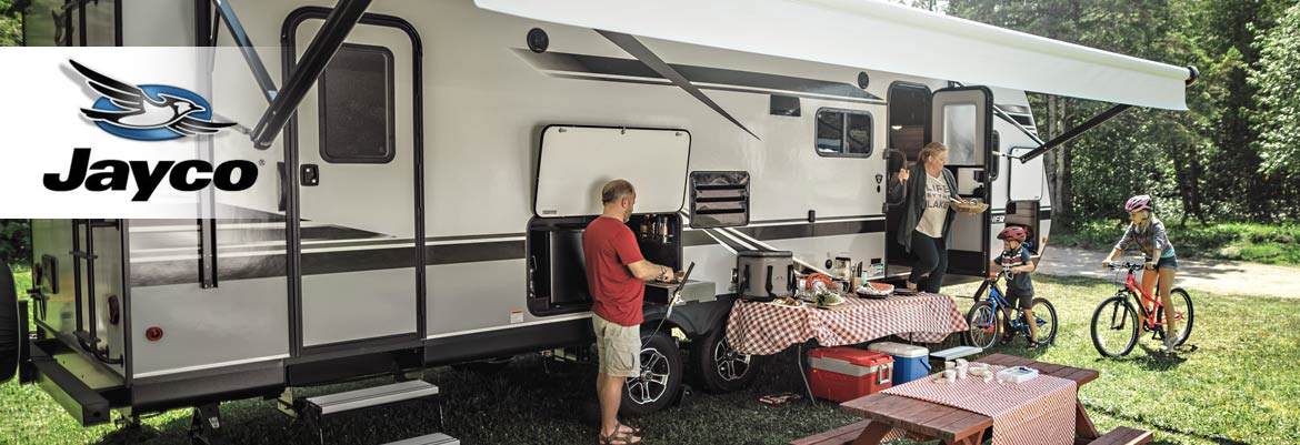 Photo of family at campground with their Jayco travel trailer.