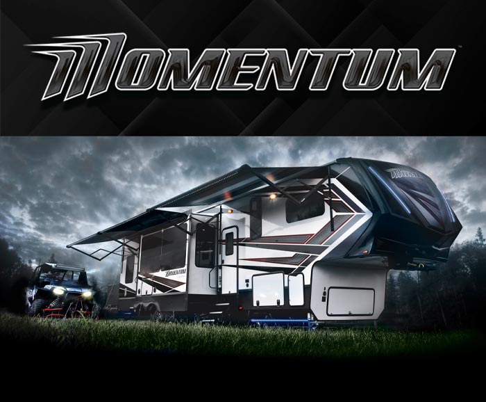Photo of Grand Design Momentum toy hauler fifth wheel with logo above.