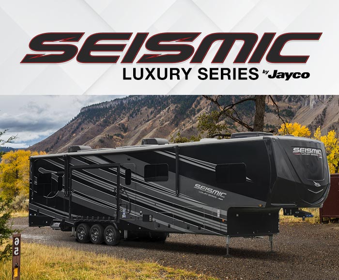 Photo of Jayco Seismic Luxury Series toy hauler with logo above.