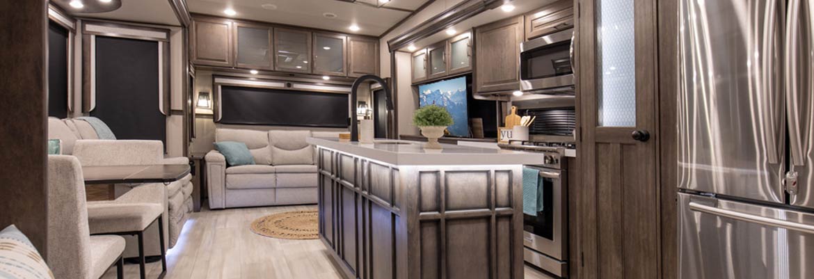 Photo of couple camping in their Grand Design Solitude fifth wheel.